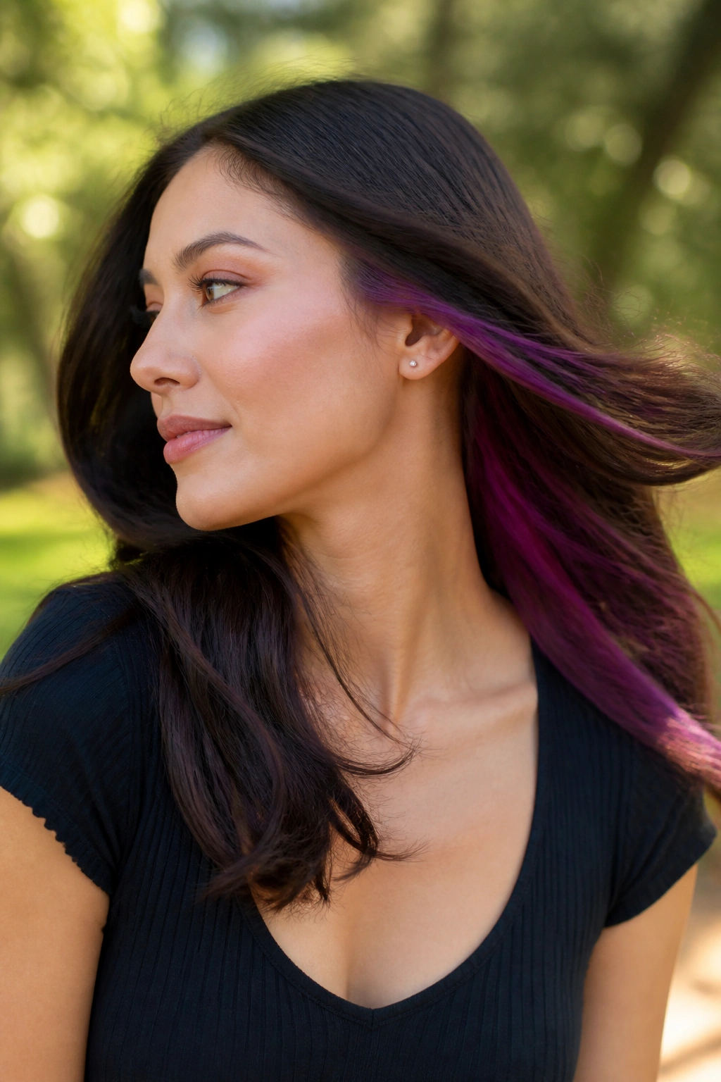 Close-up of a real woman with amethyst peekaboo under-the-top-layer hair color