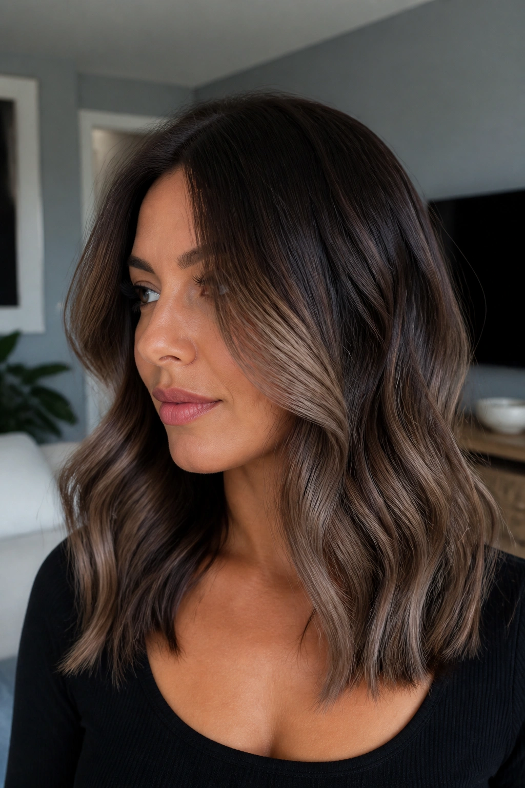 Close-up of dark brunette hair with ash brown melt and cool-toned highlights.