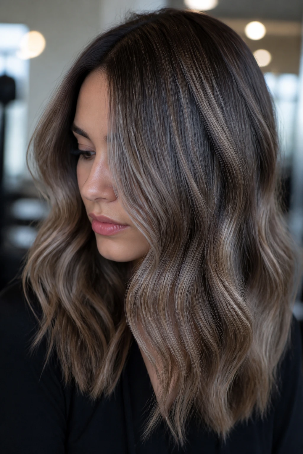 Close-up portrait of a real woman with ash brown balayage, cool-toned and modern.
