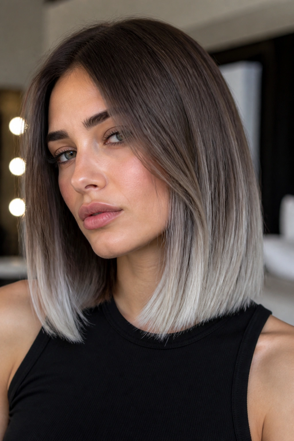 Close-up of ash brown hair with platinum-gray ends in a blunt cut