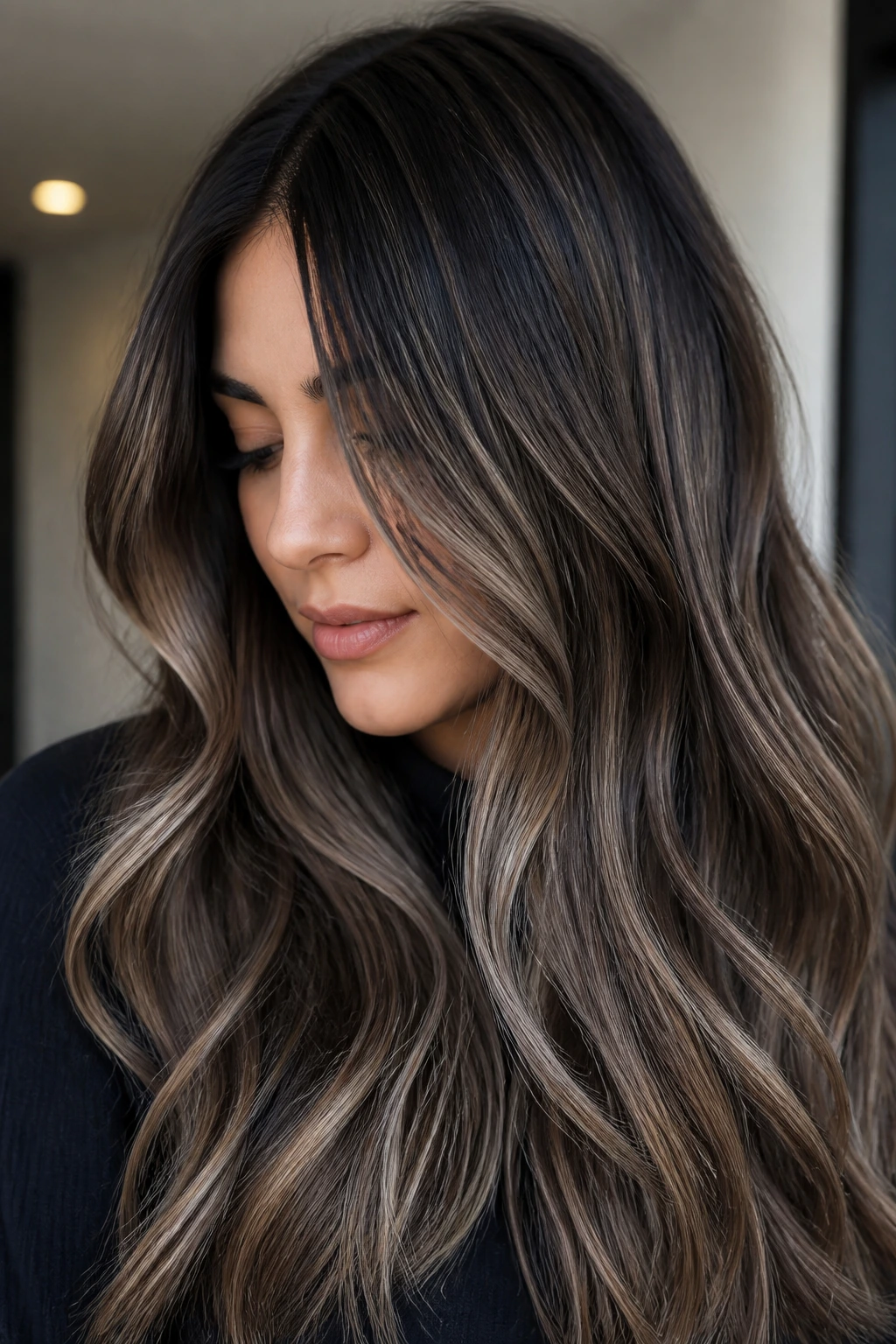Close-up portrait of a woman with ash espresso hair and vertical ribbon highlights