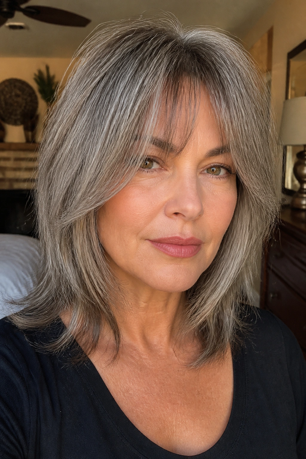 Close-up portrait of a real woman with ash gray curtain bangs