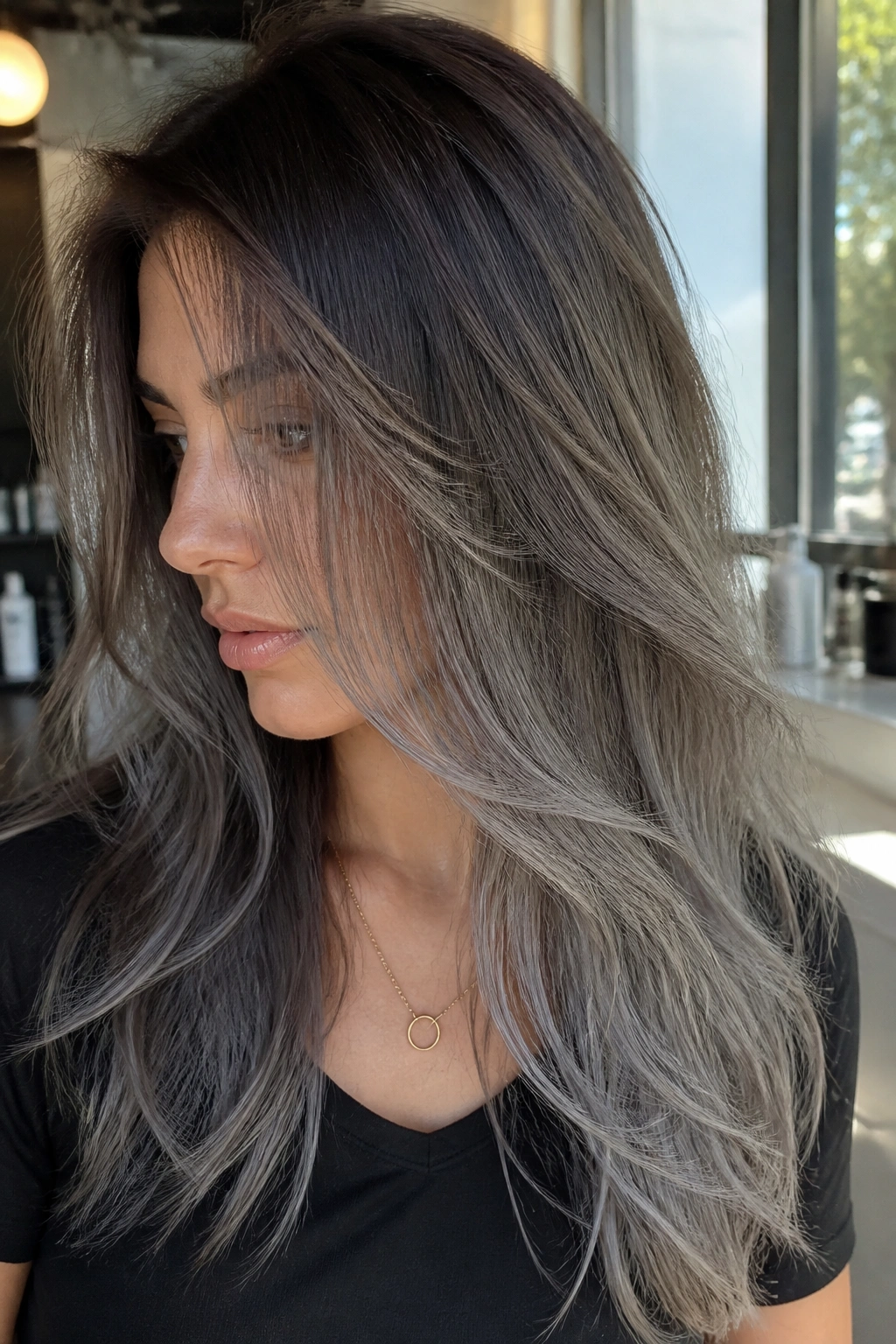 Close-up portrait of a real woman with ash-gray balayage veil on brown hair
