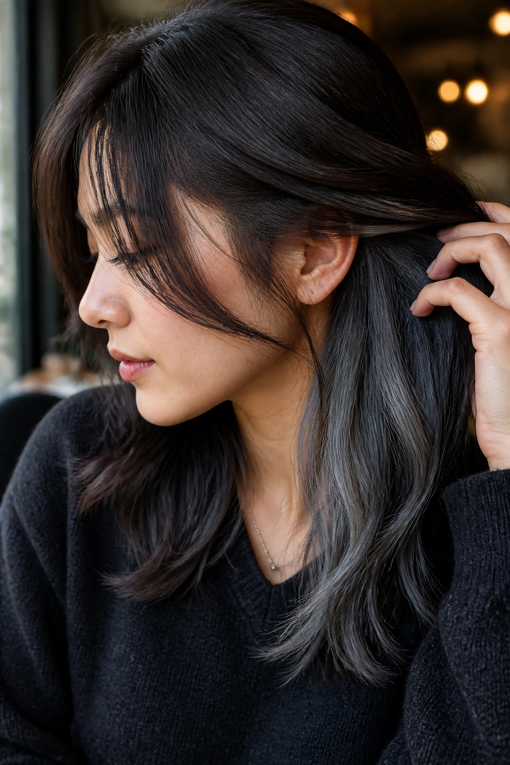 Portrait of a real woman showing ash-gray peekaboo panels under brown layers