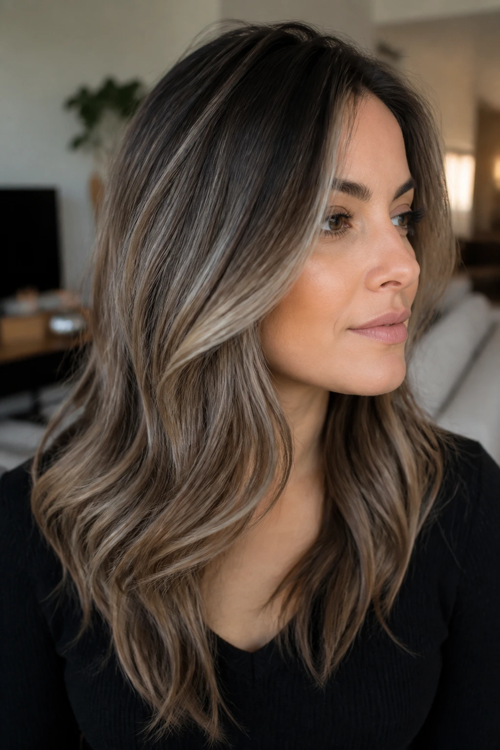 Close-up of real person with ash lowlights framing face in reverse balayage