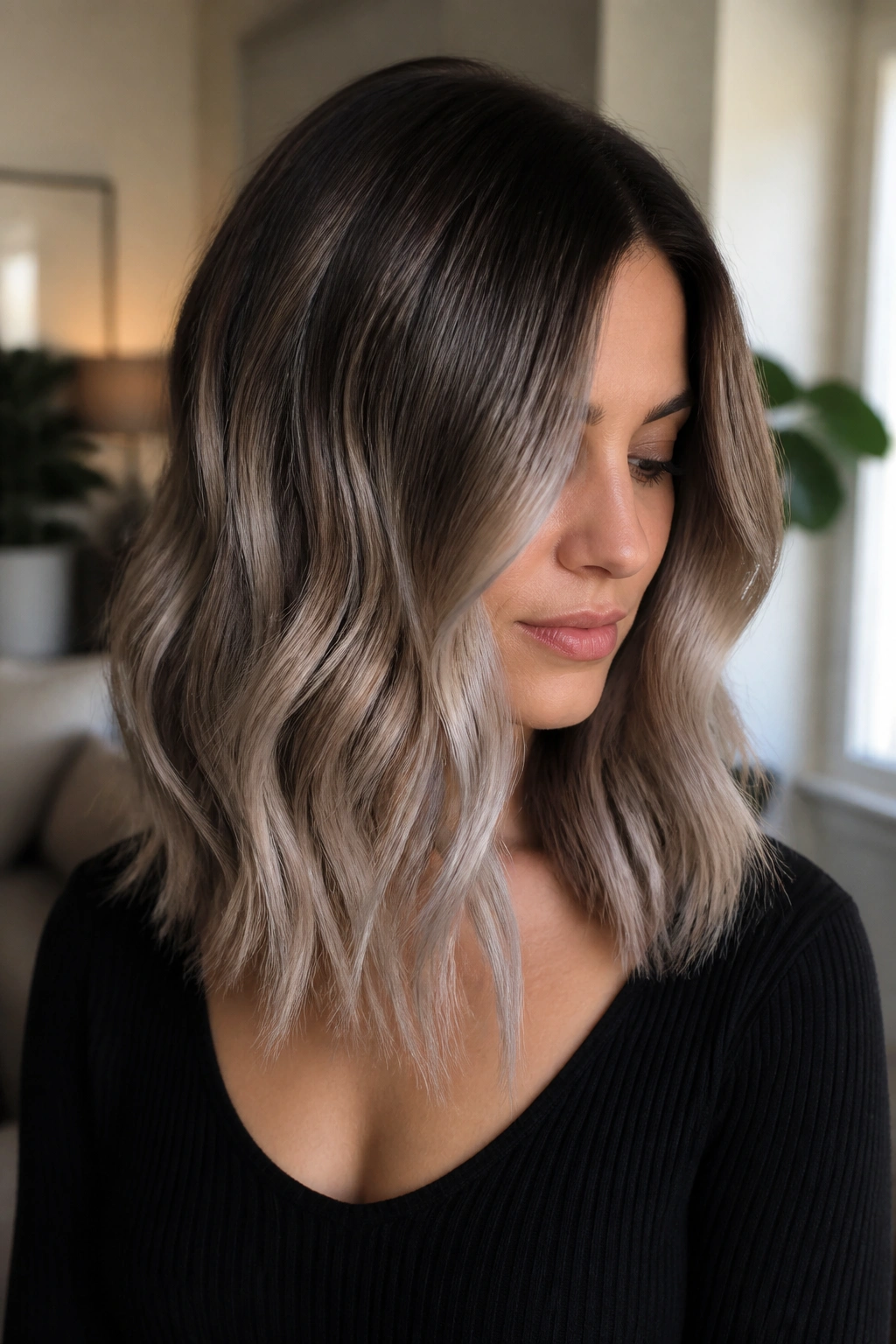 Close-up of mid-length brown hair with ash melt transition.