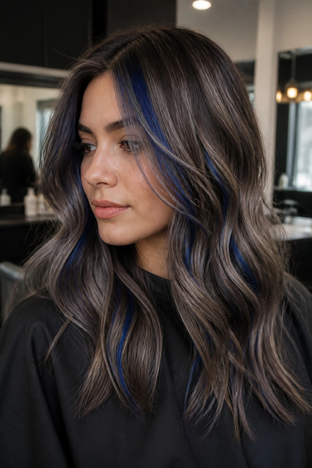 Close-up portrait of a real woman with ash mocha balayage and cobalt ribbons