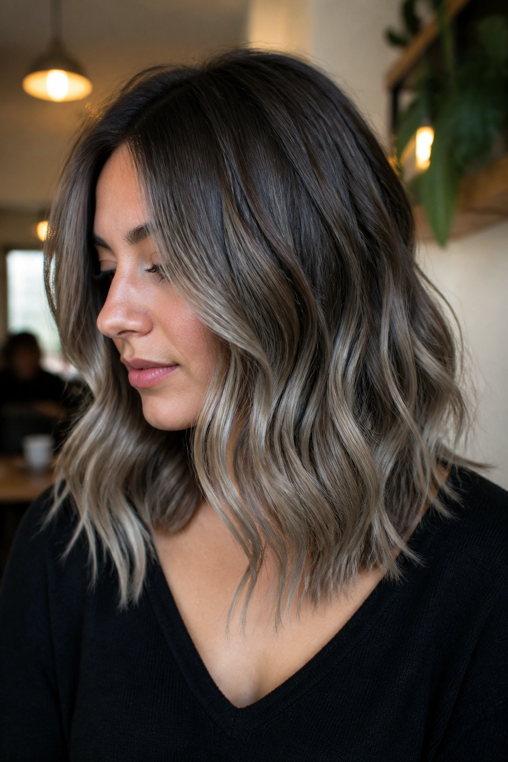 Real person with ash silver balayage on warm brunette hair