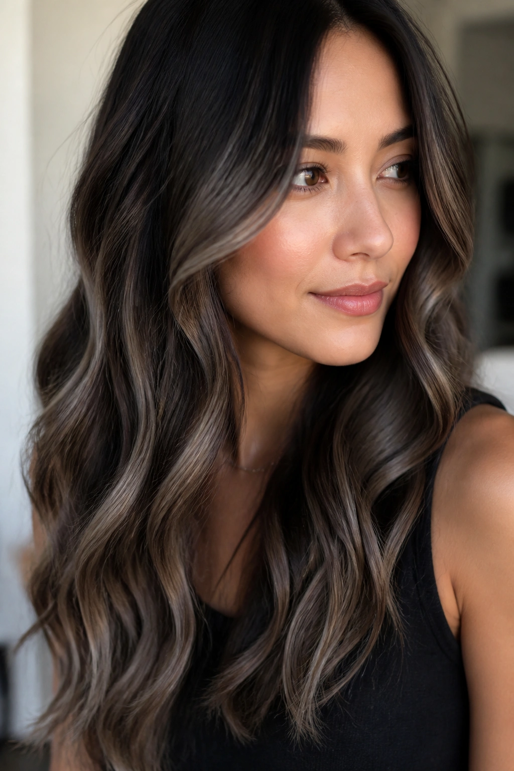Close-up of dark brown hair with ashy balayage through lengths