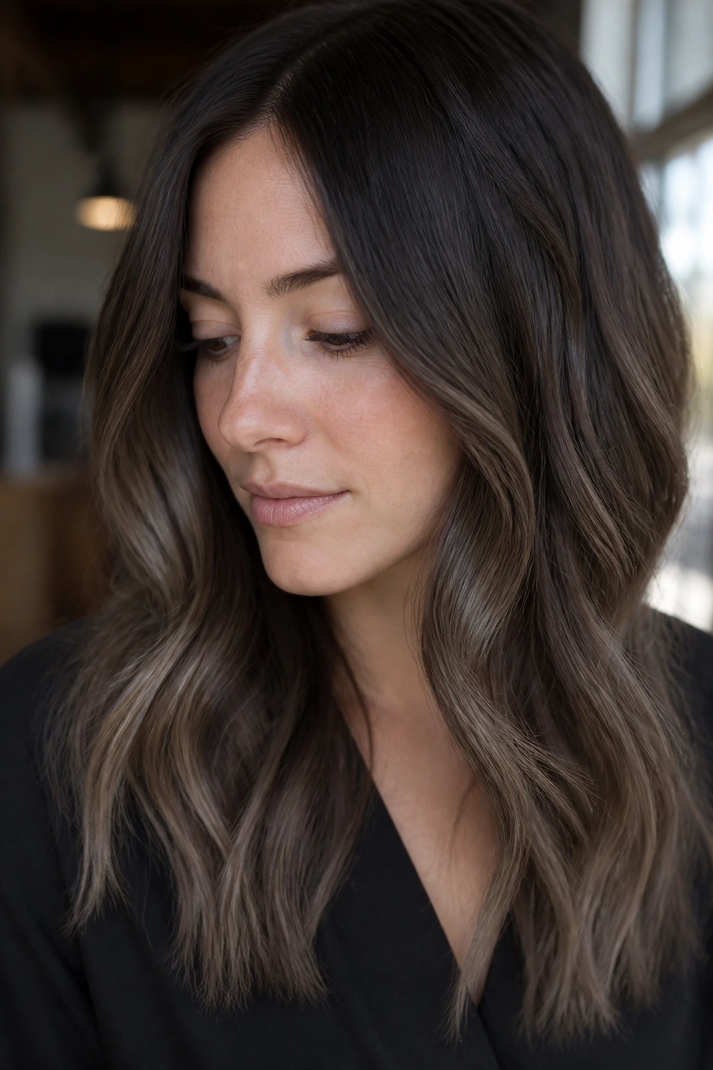 Close-up of a real woman with ashy chocolate ends on dark hair