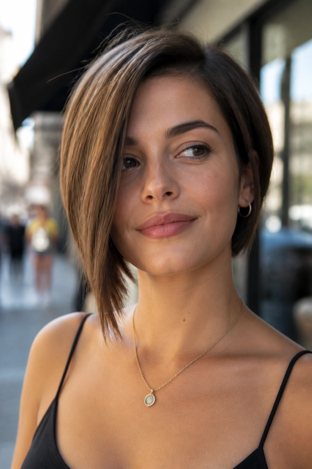 Portrait of a real girl with an asymmetrical bob on a sunny street