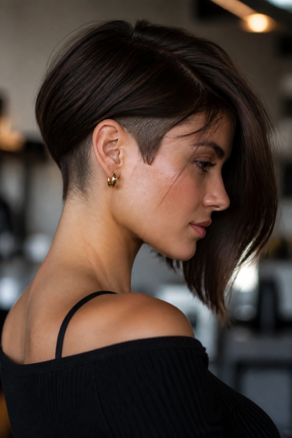 Profile view of an asymmetrical lob with a shaved side at the nape.