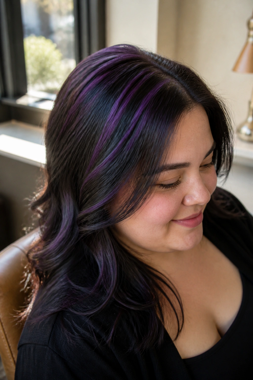 Close-up portrait of a real woman with black hair featuring purple crown babylights.