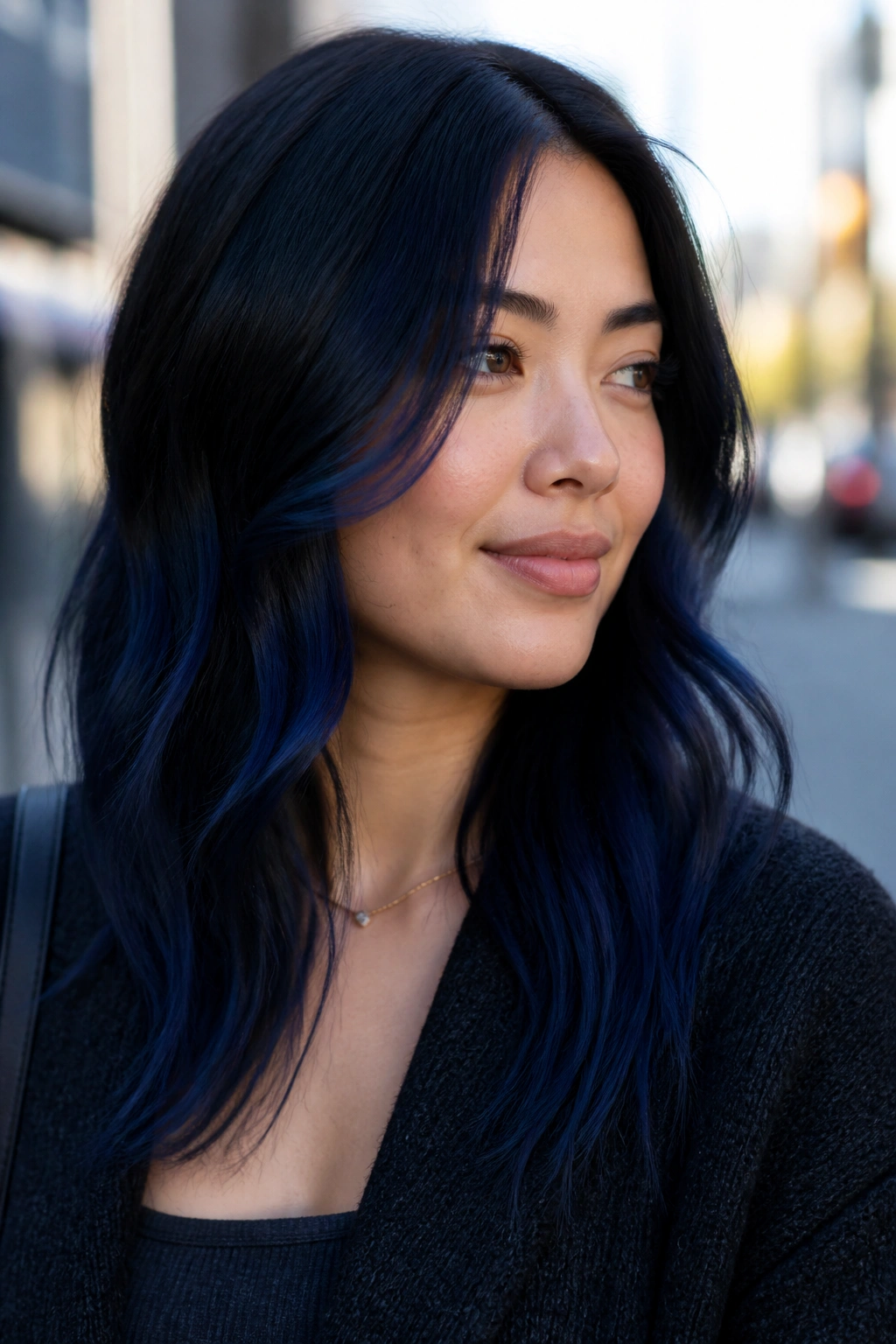 Close-up of a real woman with balayage starting below the cheekbone and fading down the hair.