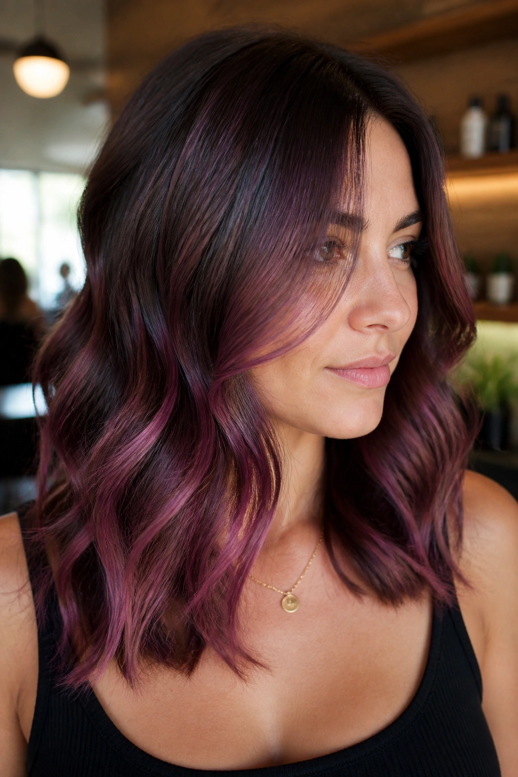 Close-up of real woman with plum-kissed balayage on brunette hair