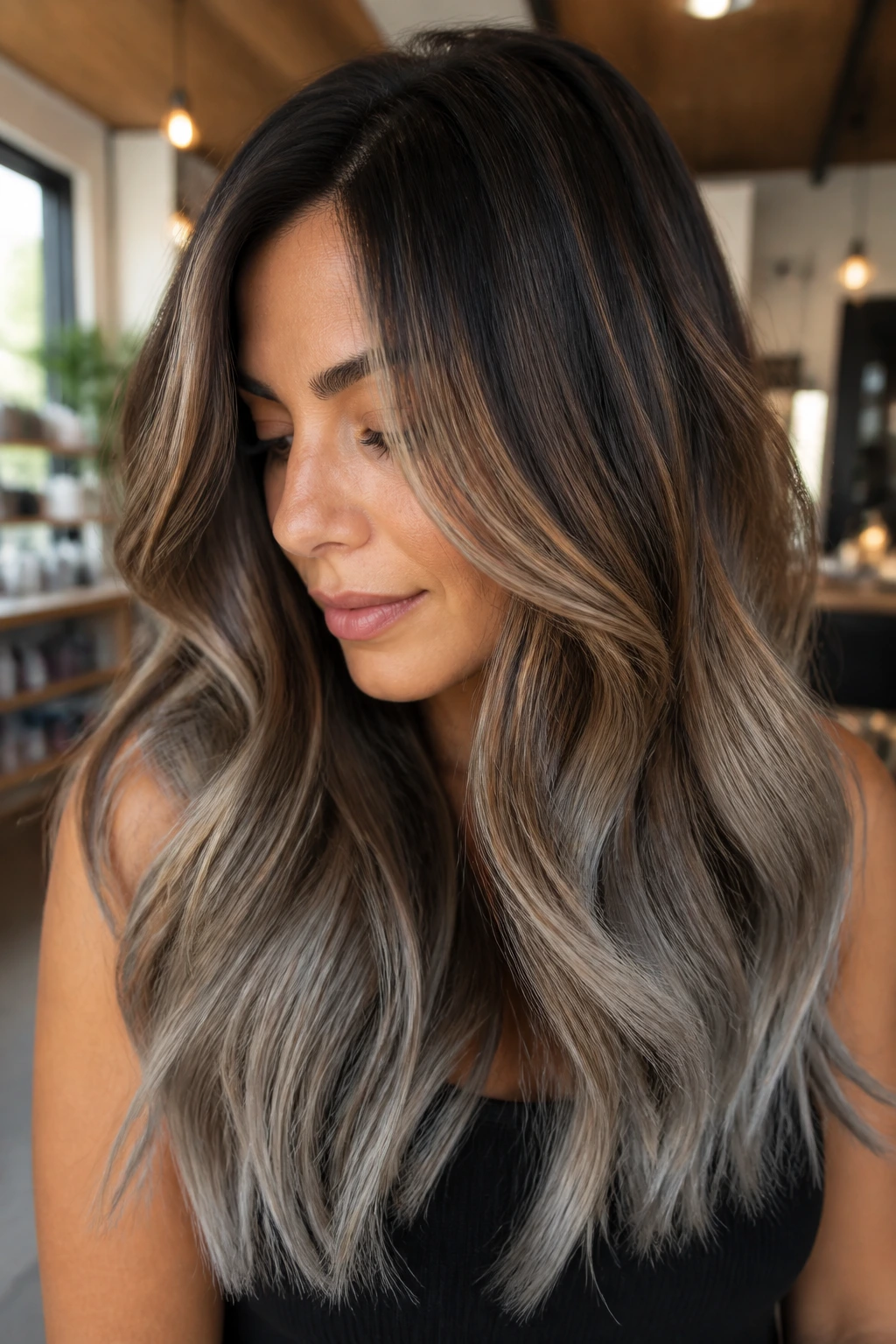 Close-up portrait of a warm brunette with bronze-to-gray balayage color melt