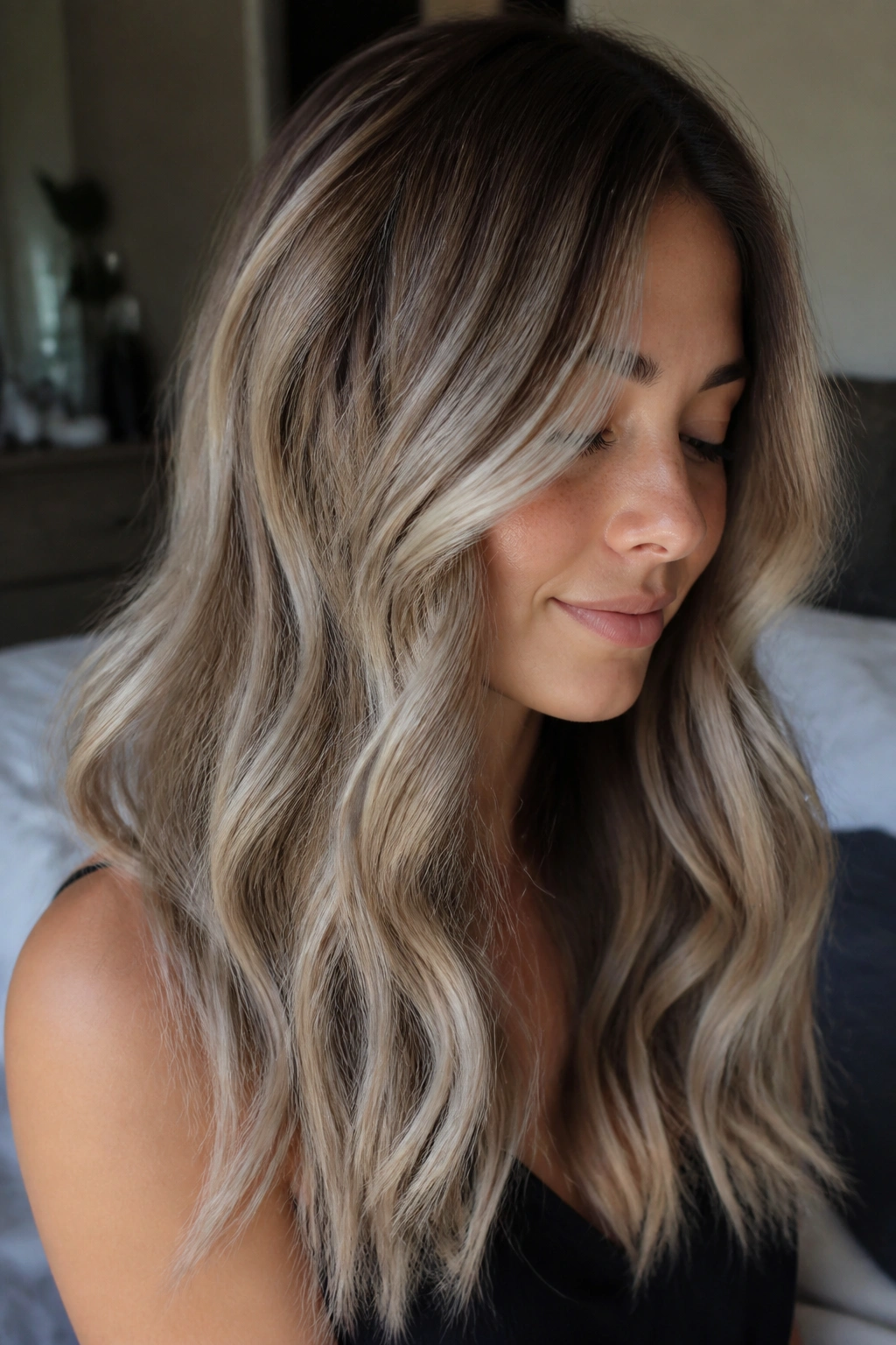 Close-up portrait of a real woman with beige ash balayage on warm undertones