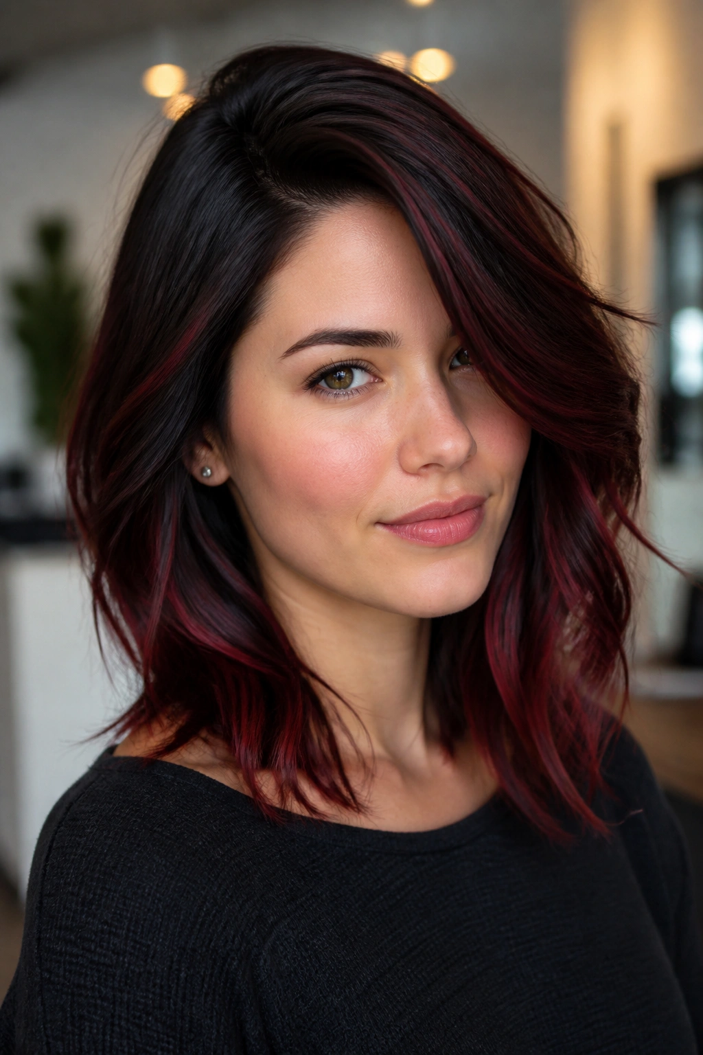 Close-up portrait of a real woman with black cherry balayage and a deep side part