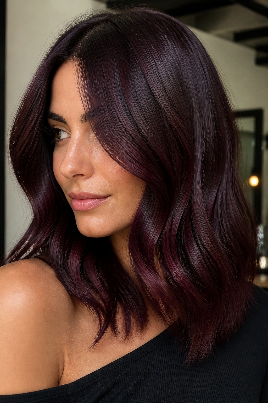 Close-up portrait of a woman with black cherry brown hair showing cool cherry tones