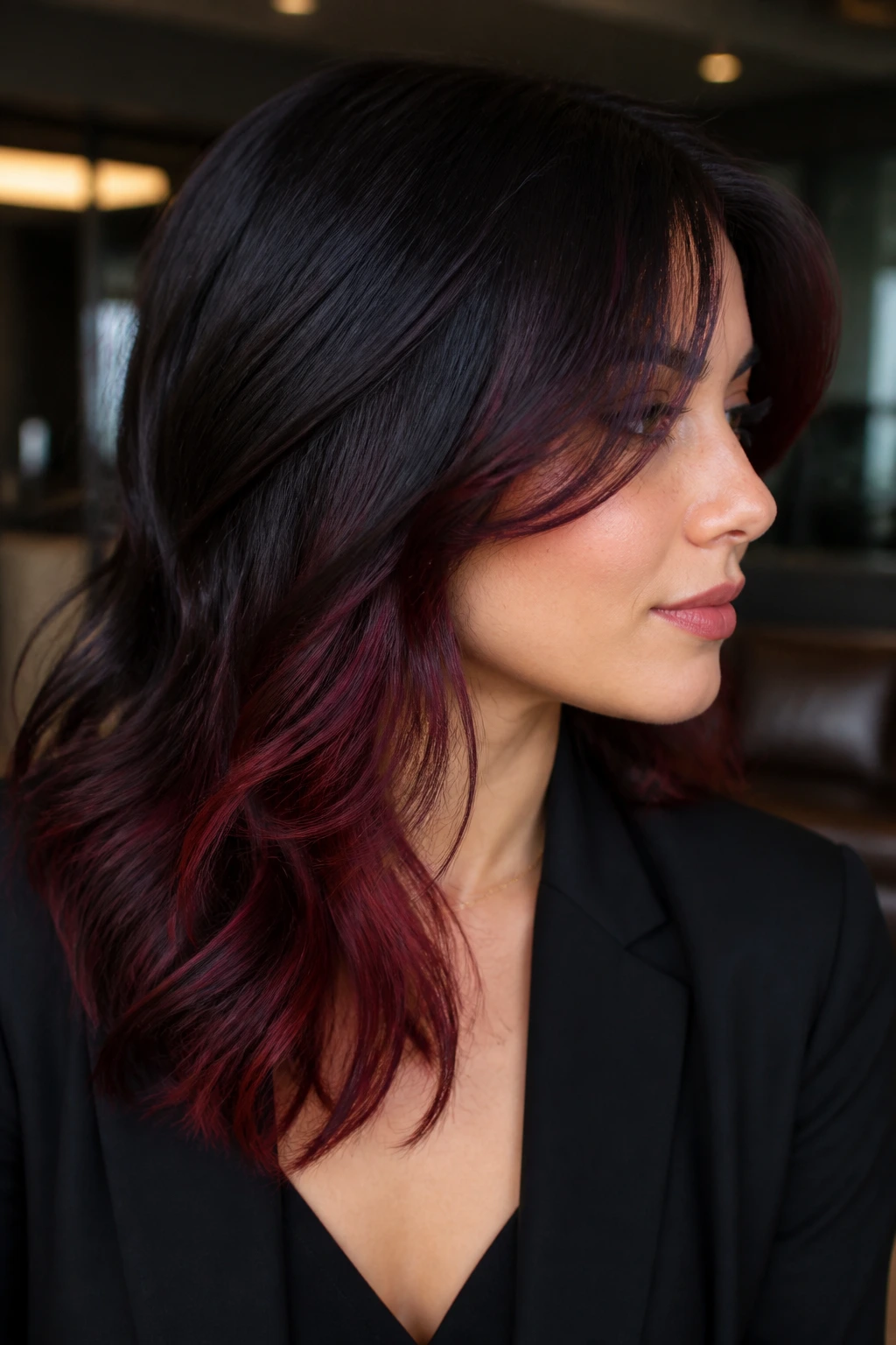 Close-up of a real woman showing hidden red panels in black cherry hair.