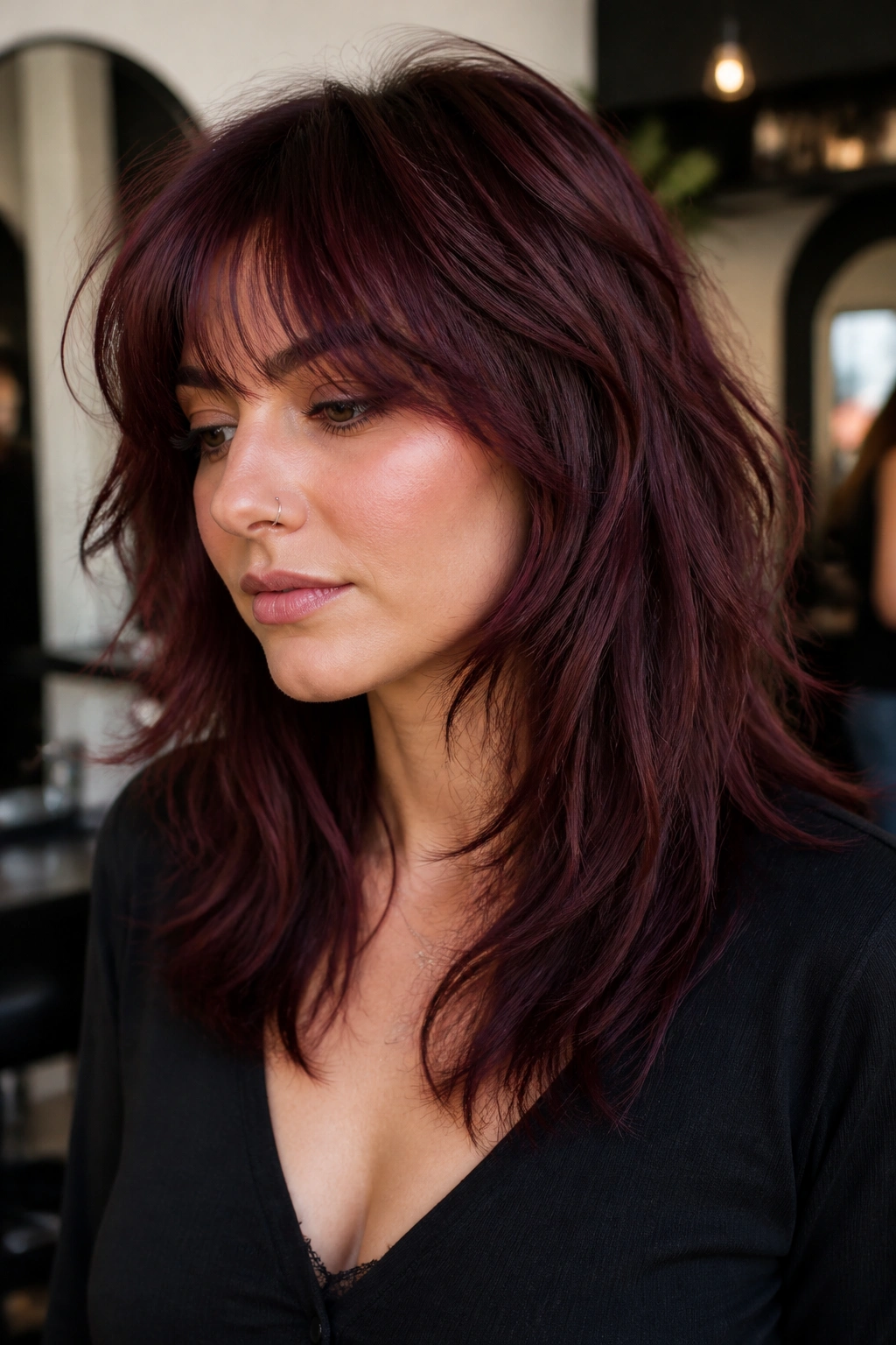 Portrait of a real woman with black cherry shag and feathered fringe