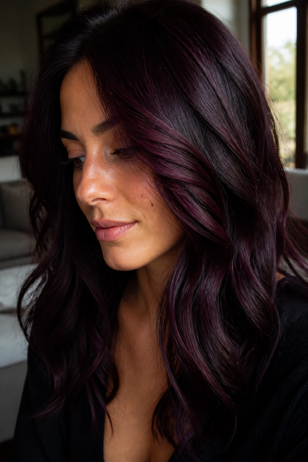 Close-up of brunette hair with deep wine-dark black cherry-violet tones.