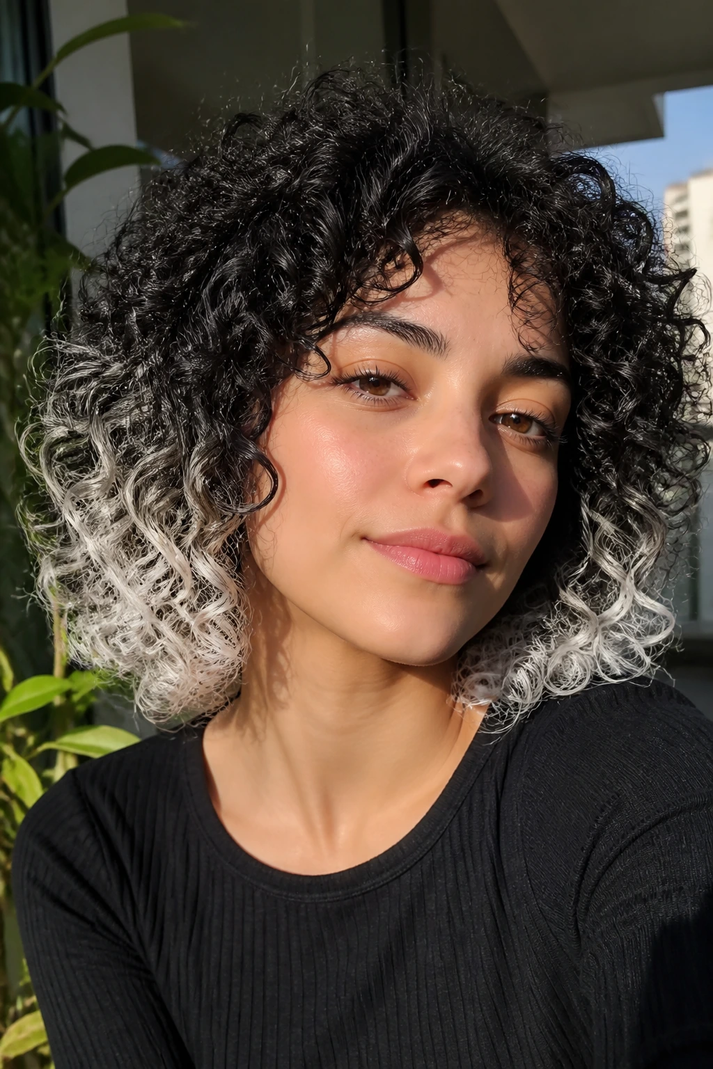 Close-up of a real person with black curls and white-tipped ends.