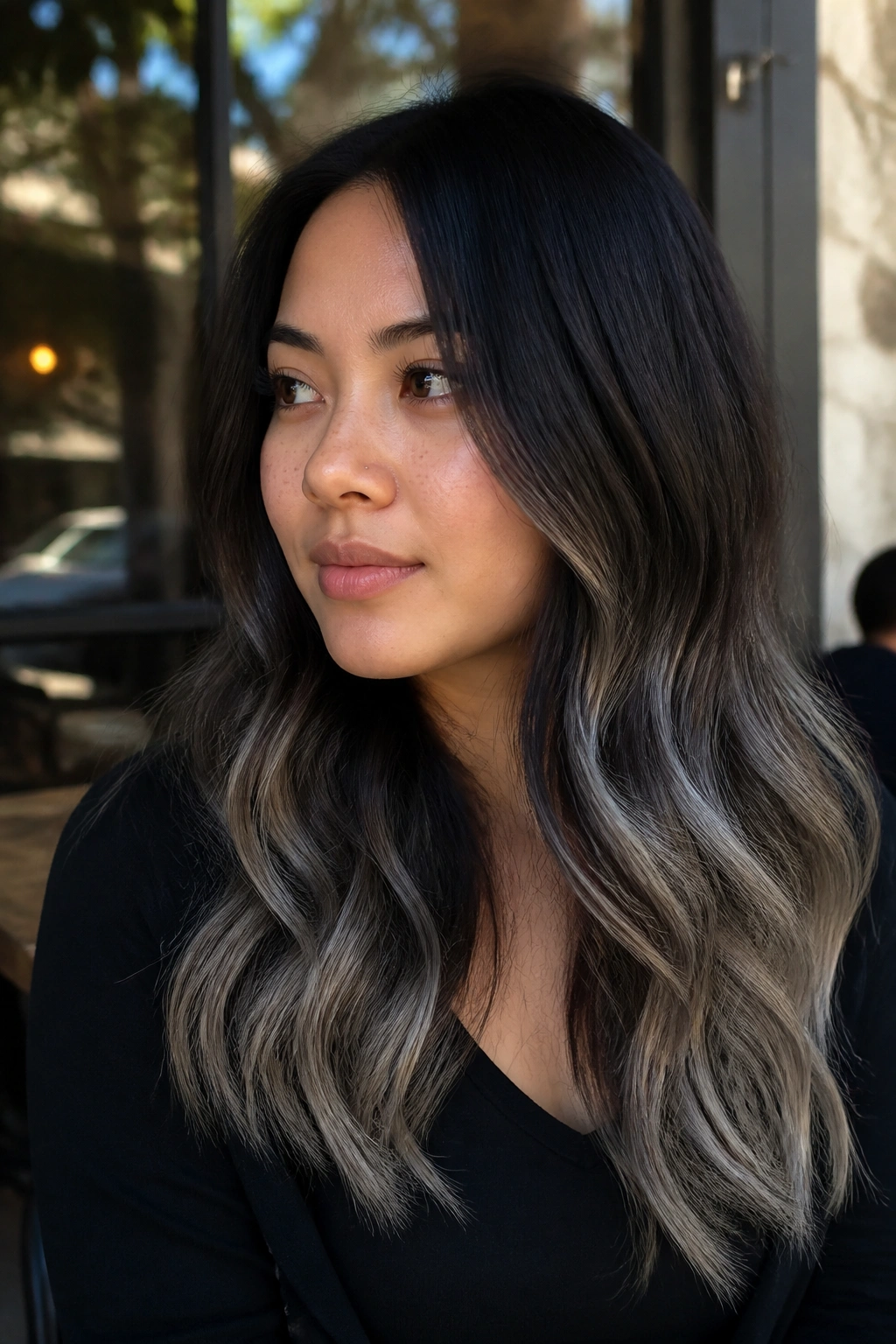 Close-up of a real person with black-to-gray ombré ends on hair