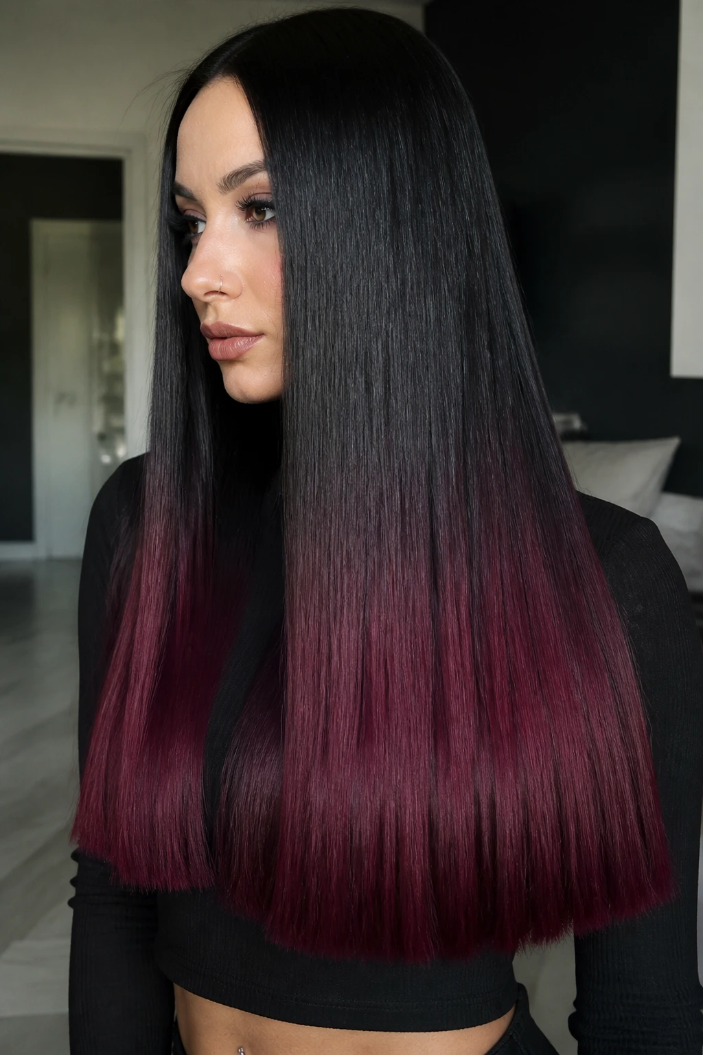 Close-up of real person with black hair and velvet burgundy blunt long ends in soft daylight