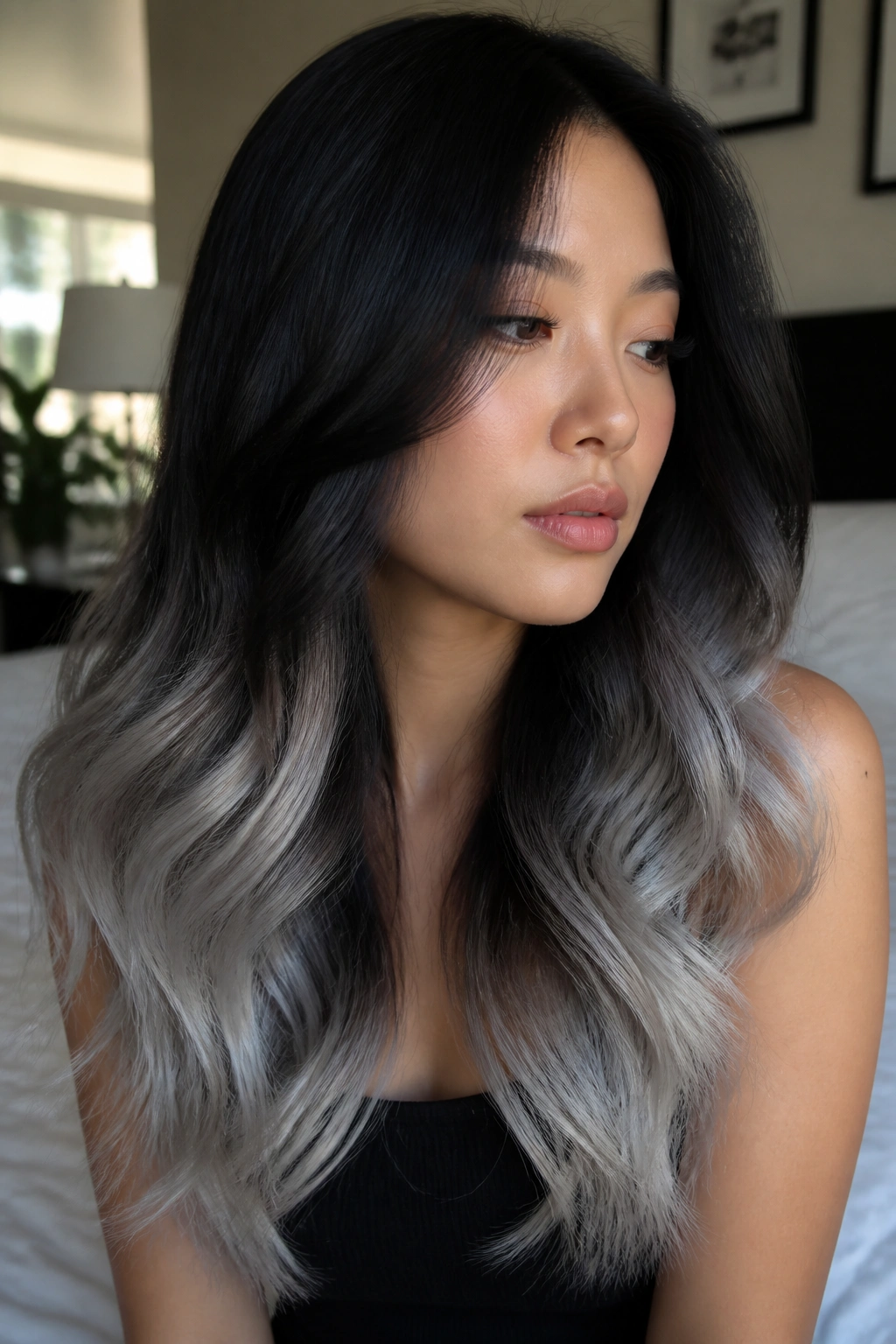 Close-up of a real woman with black-to-silver ombre hair in a soft melt.