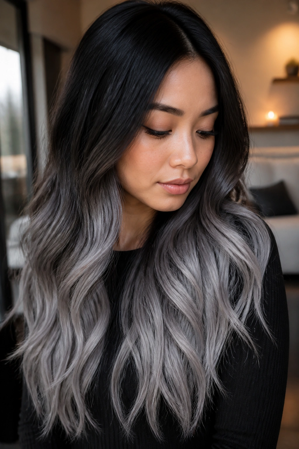Close-up of long hair transitioning from black roots to smoky silver ends