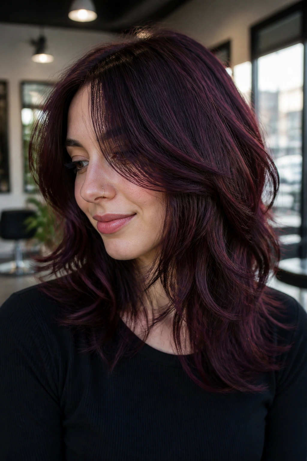 Close-up portrait of a woman with layered blue-toned blackcurrant cherry hair