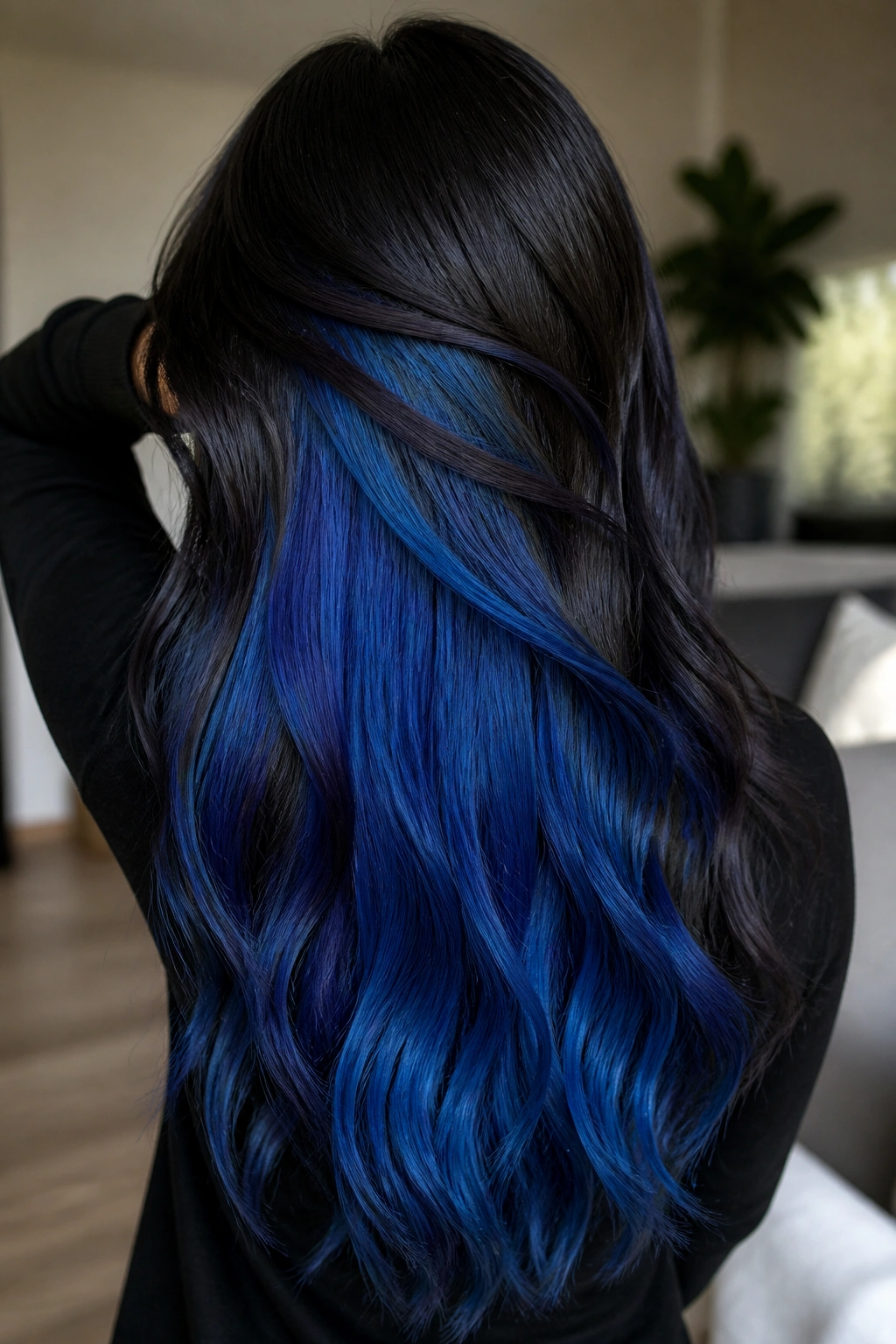 Back-of-head portrait showing blue peekaboo underlayer in long hair