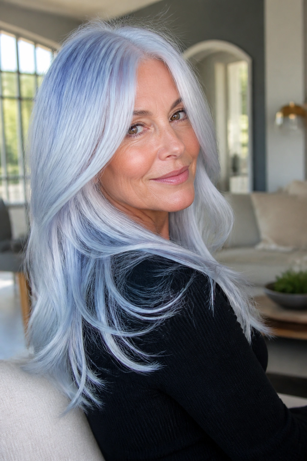 Real person with long layered hair finished in blue-white gloss for cool undertones.