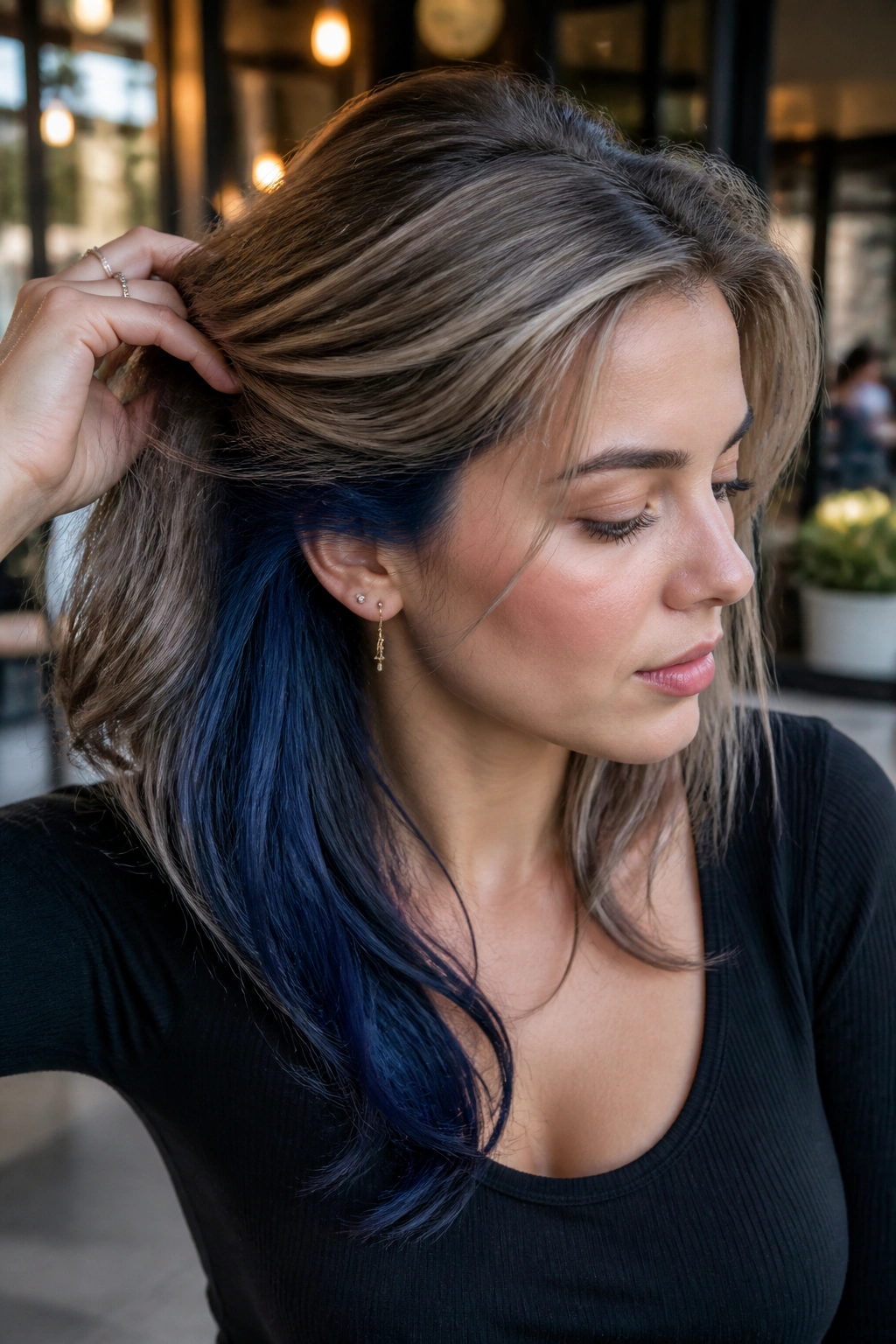 Cool bronde hair with marine blue underlayer peeking from under the top