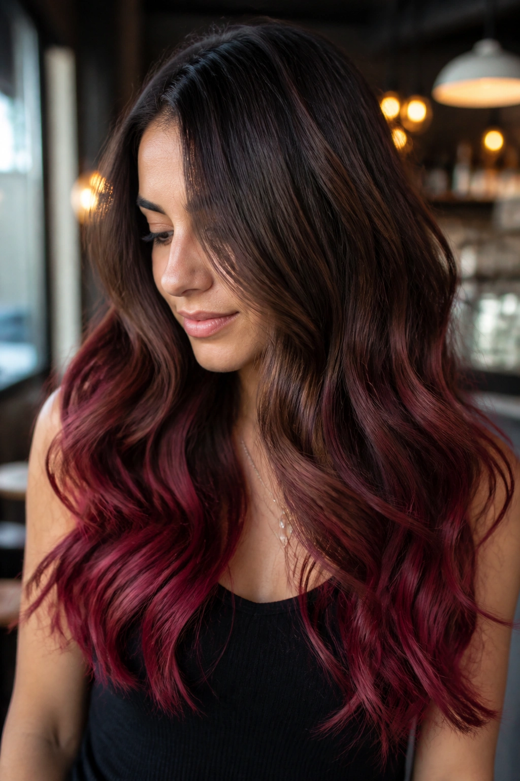 Close-up of long hair with brown balayage fading to cranberry ends