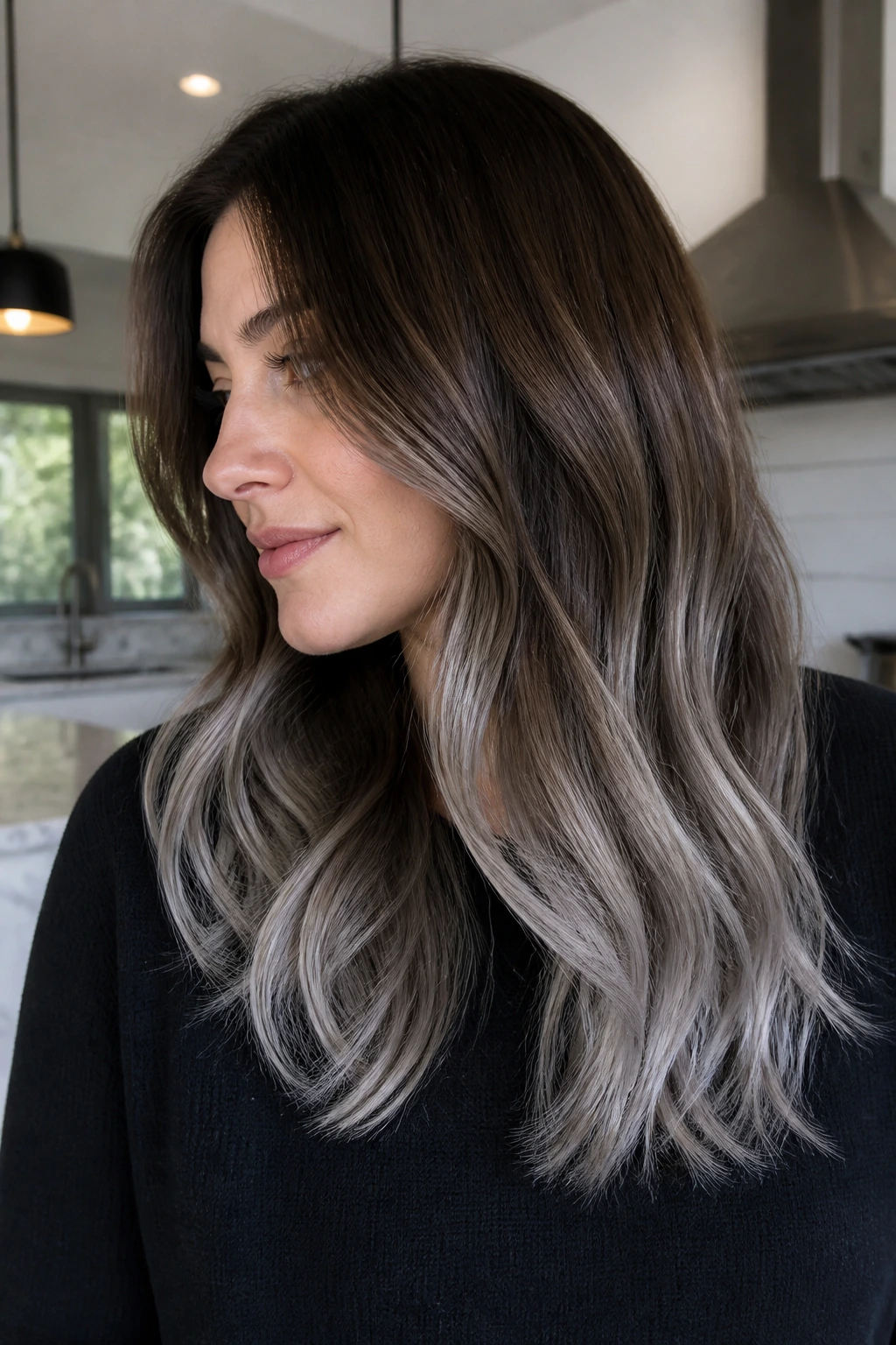 Close-up portrait of a real woman with brushed-metal grey ends on brown hair