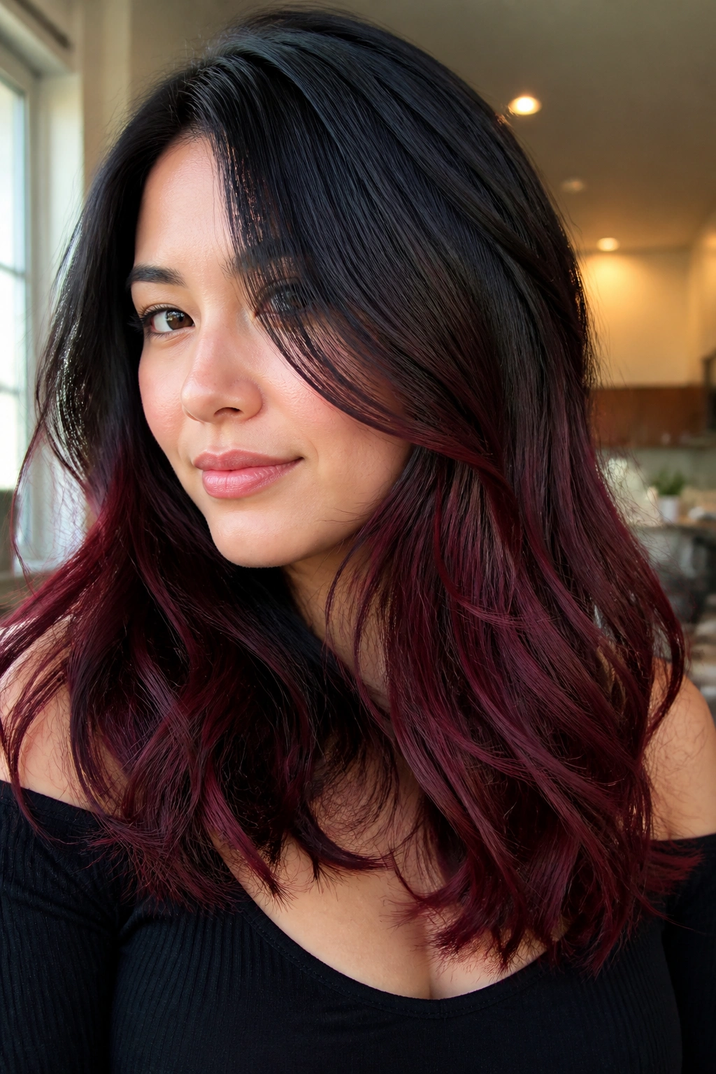 Close-up of a real woman with burgundy balayage starting below cheekbone