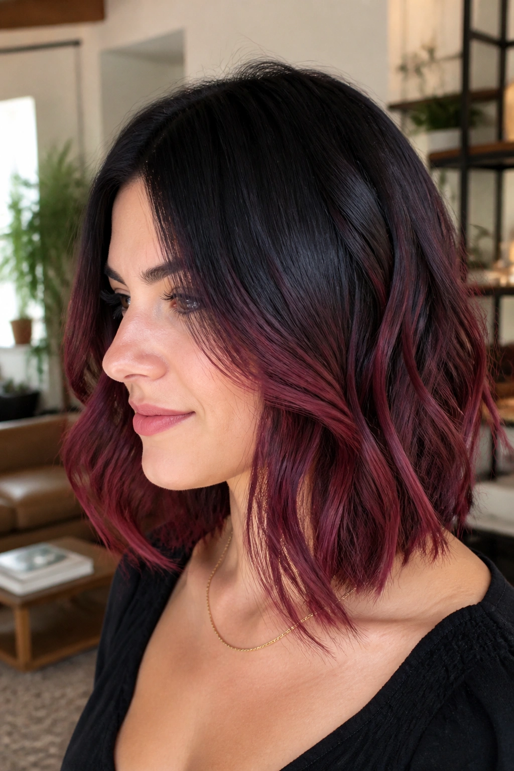 Portrait of a real woman with burgundy balayage on a lob and lighter pieces starting below the cheekbone
