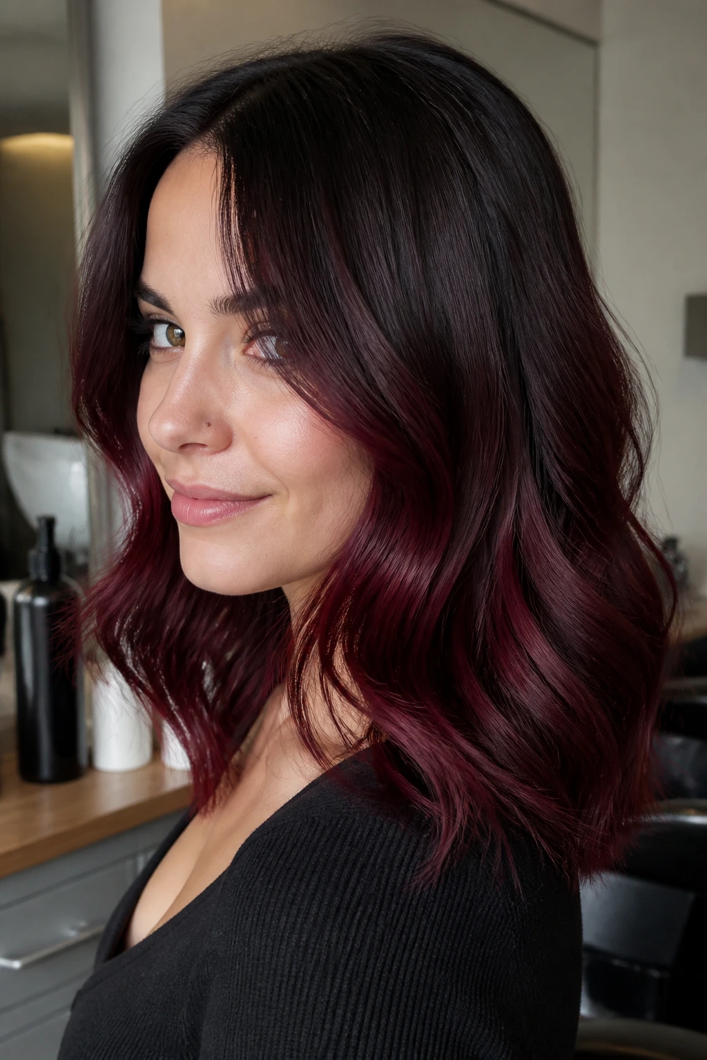 Portrait of a person with espresso-rooted black cherry burgundy hair in warm light