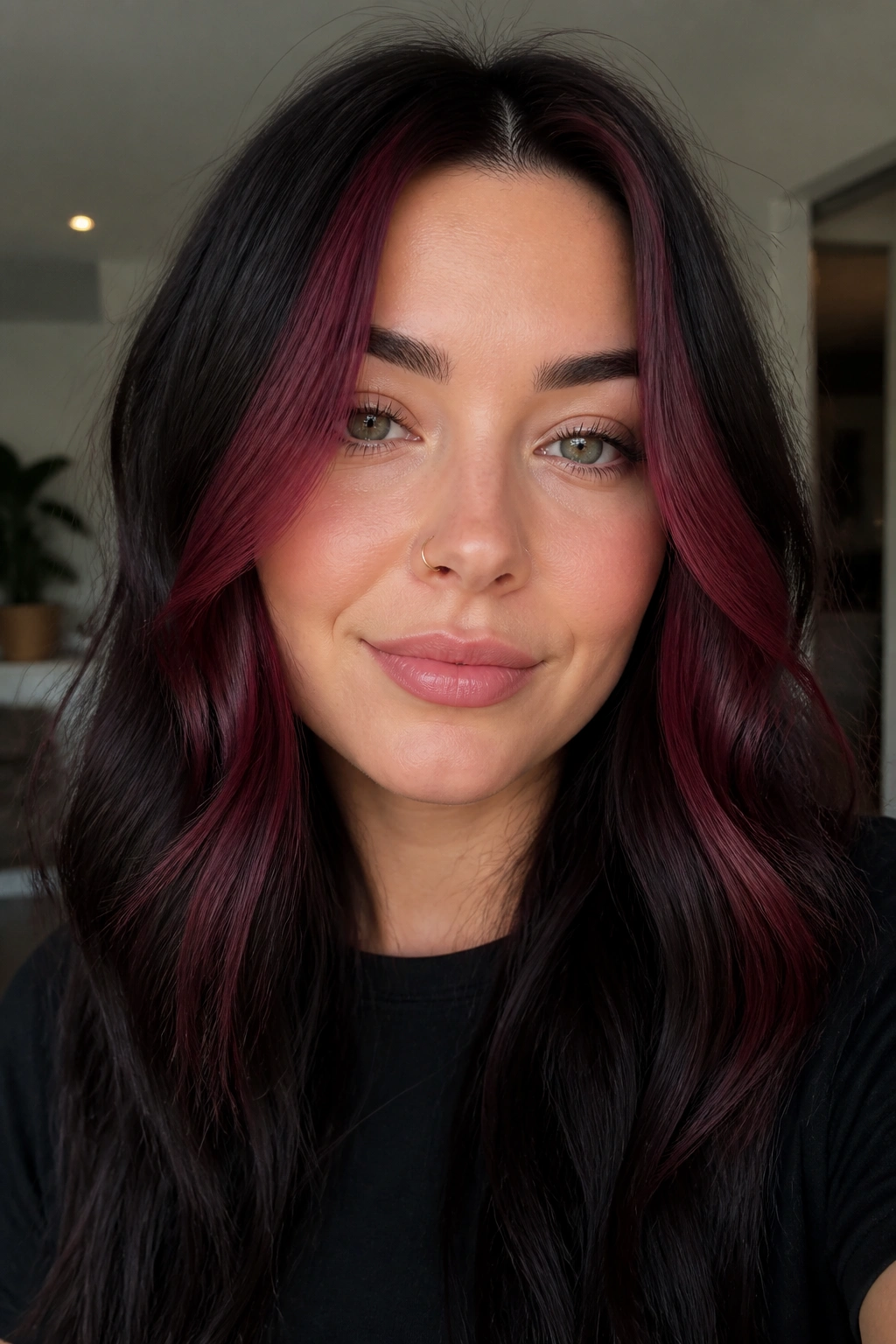 Face-framing burgundy money piece on dark brunette hair