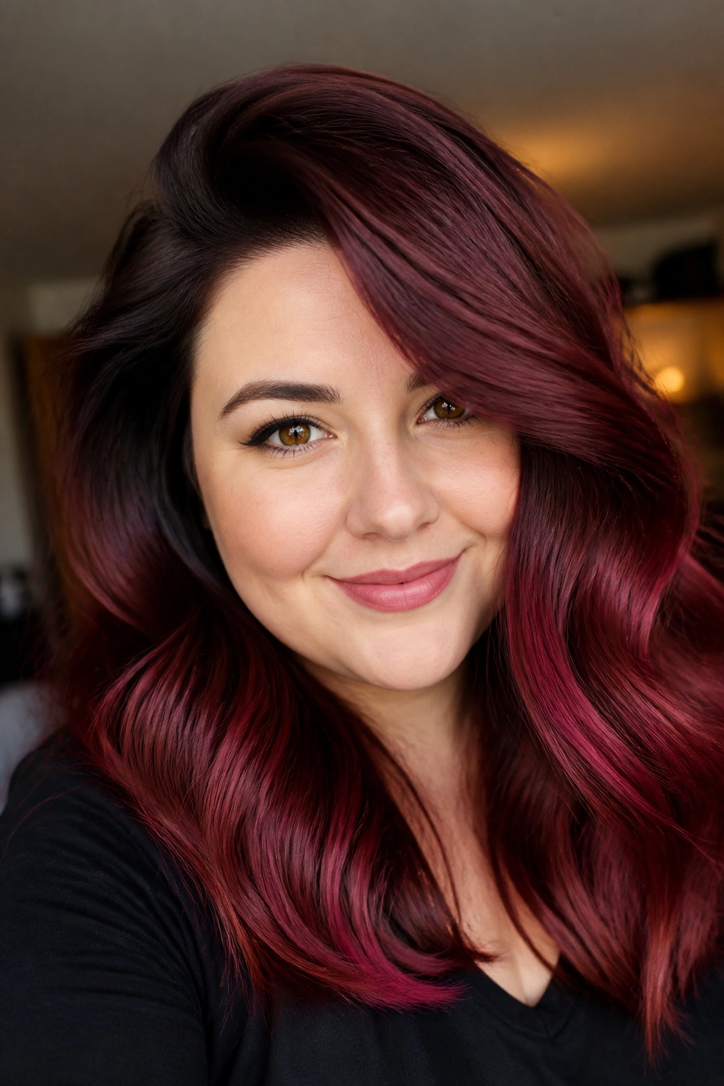 Portrait of a woman with burgundy ombre and side-swept volume