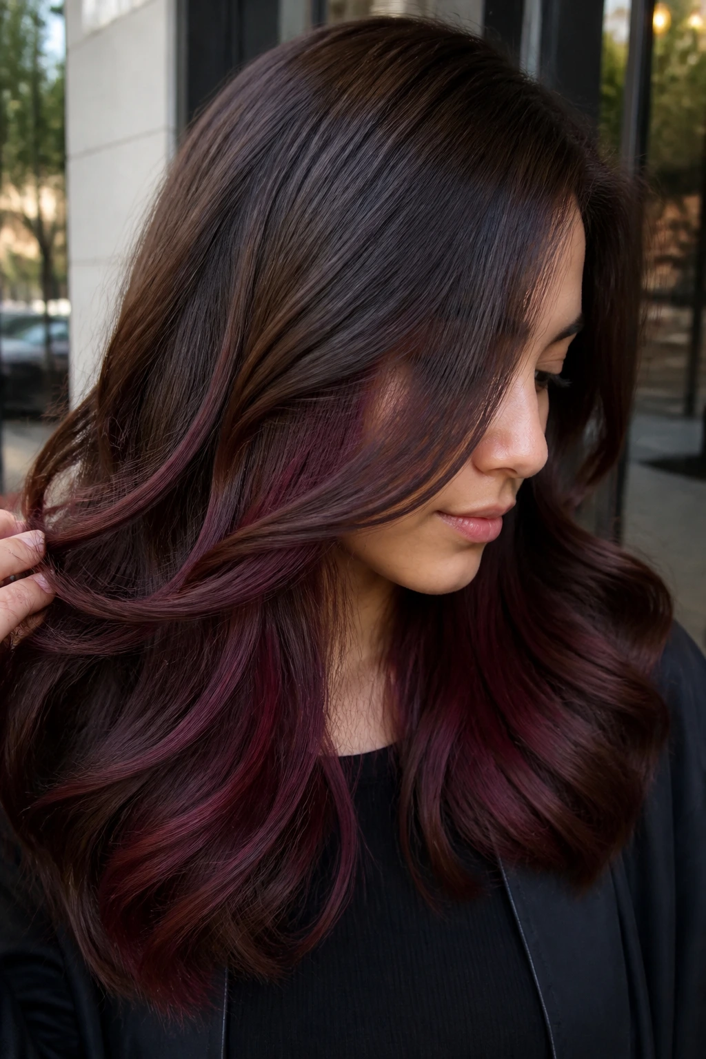 Real person with burgundy peekaboo layers in brown hair, subtle color under top layer