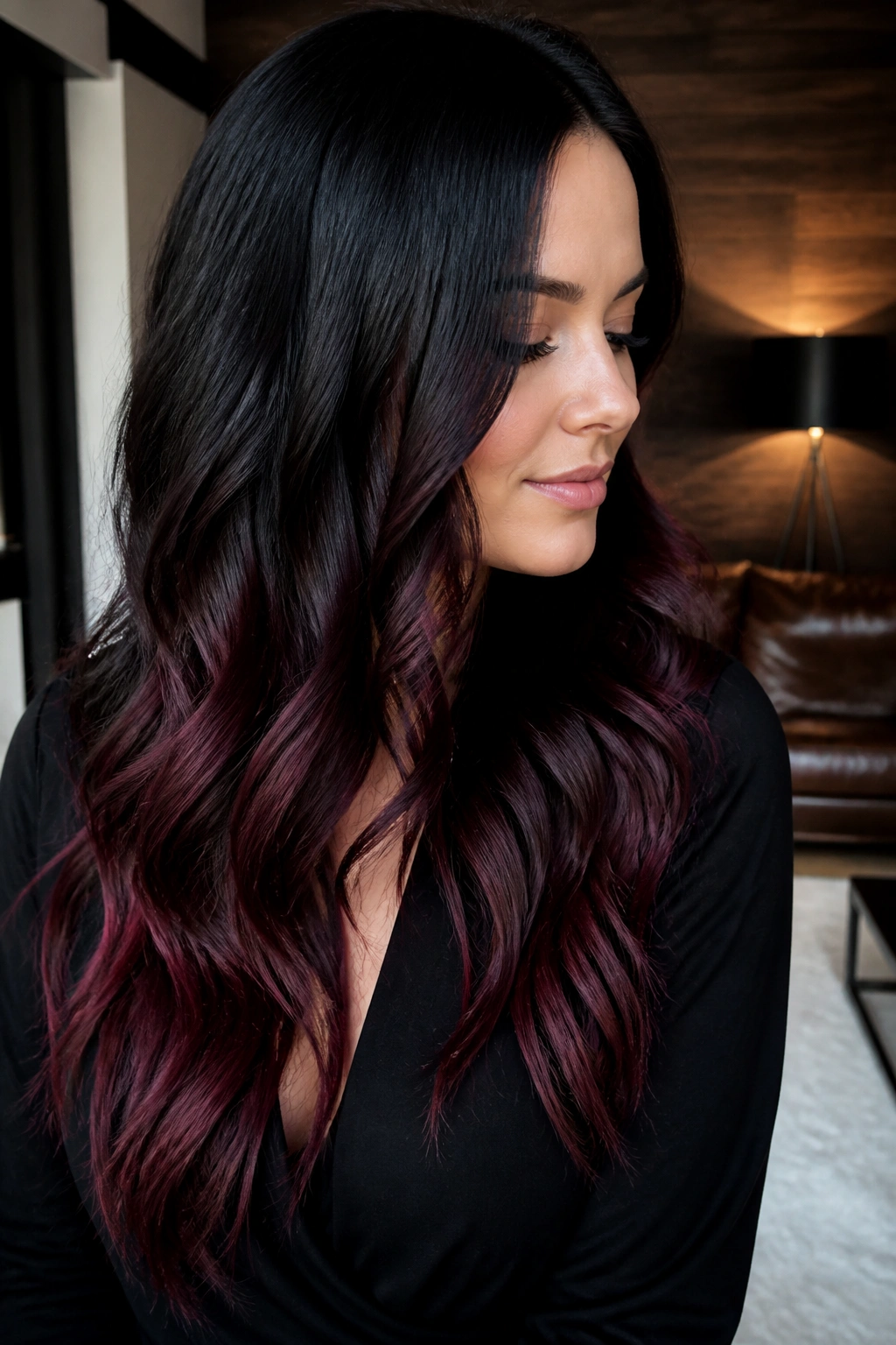 Close-up portrait of a real woman with burgundy wine ends under black hair.
