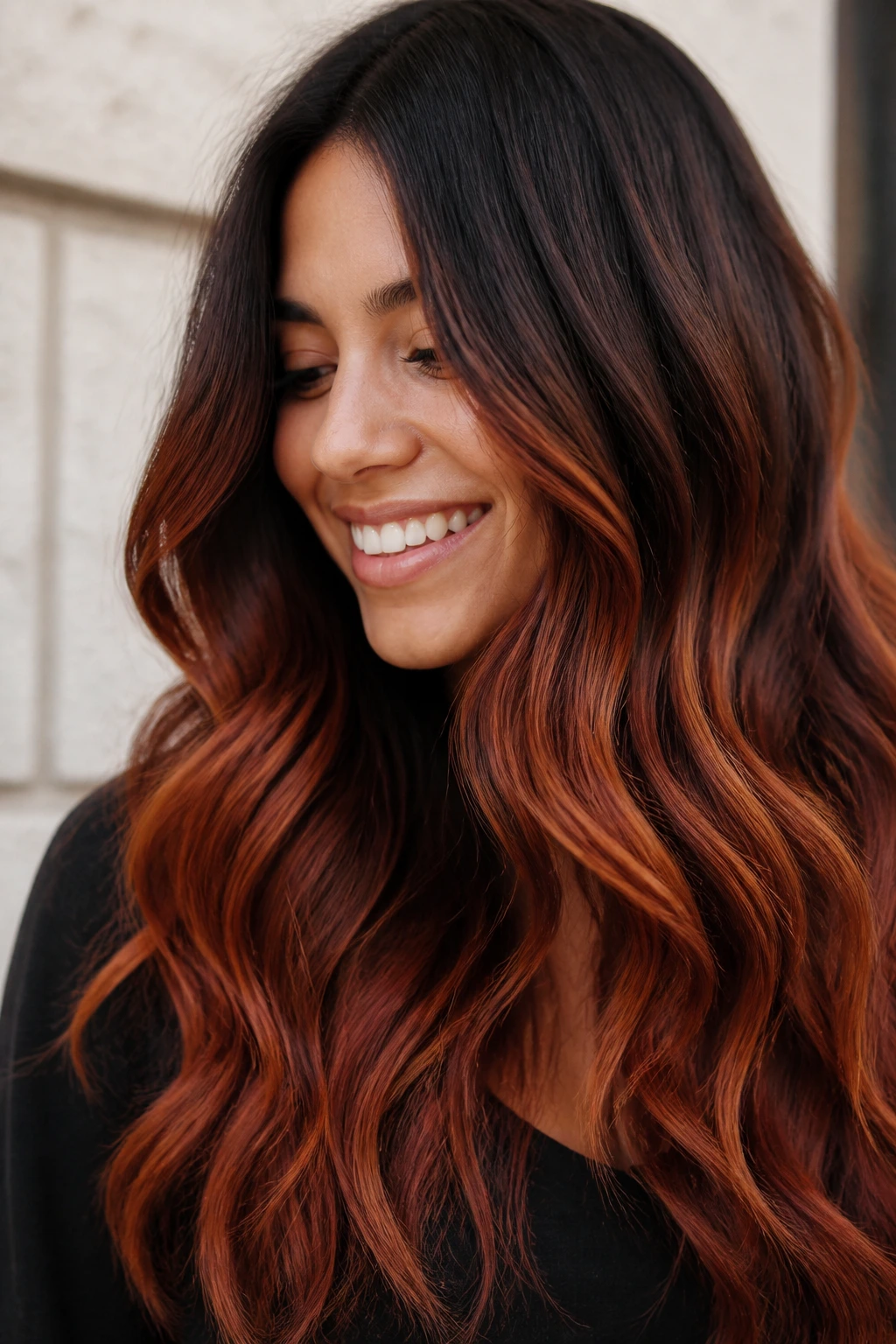 Close-up of a real woman with burnt sienna ombré balayage on long brown hair
