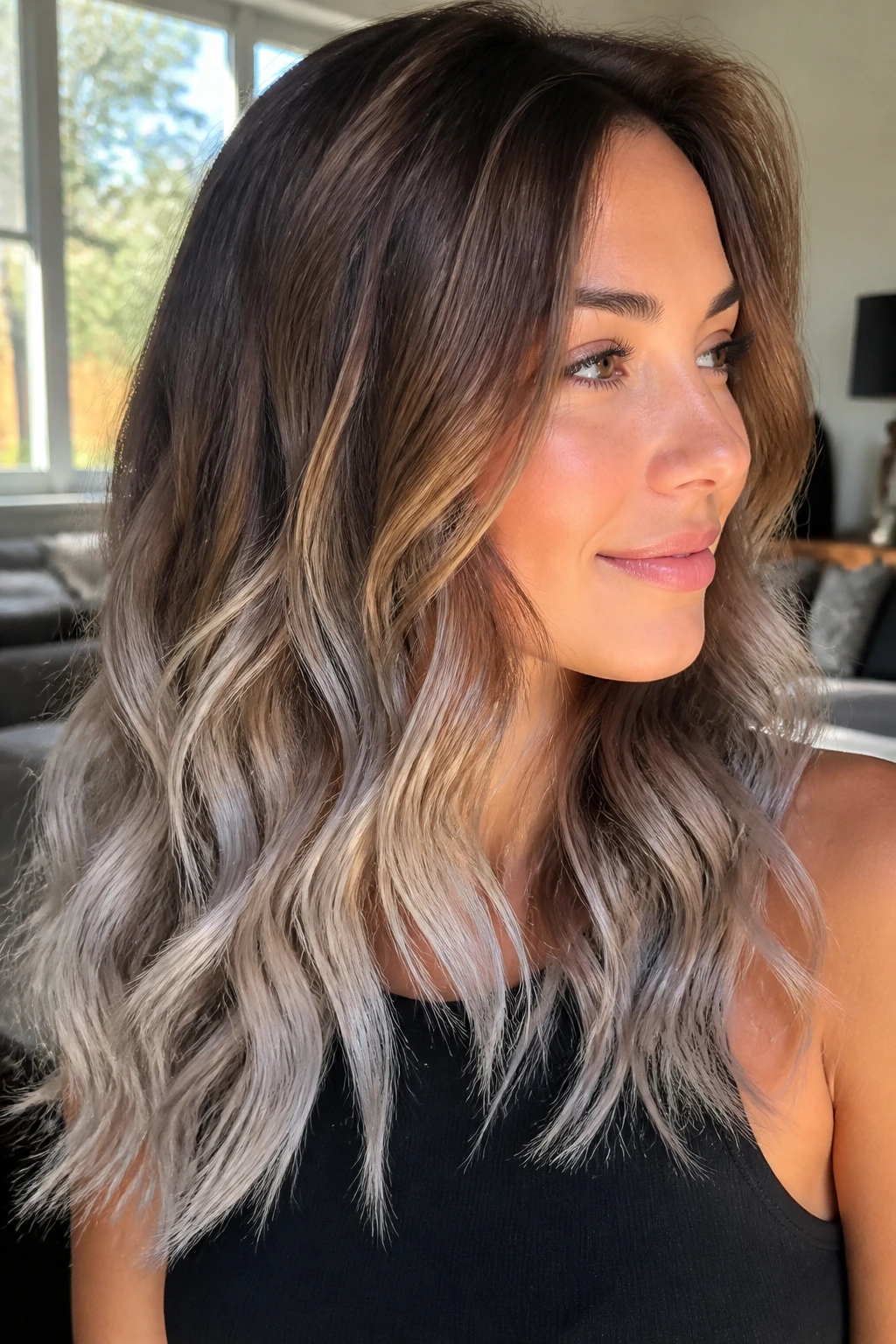 Close-up of real woman with caramel base and frosted ends on wavy hair