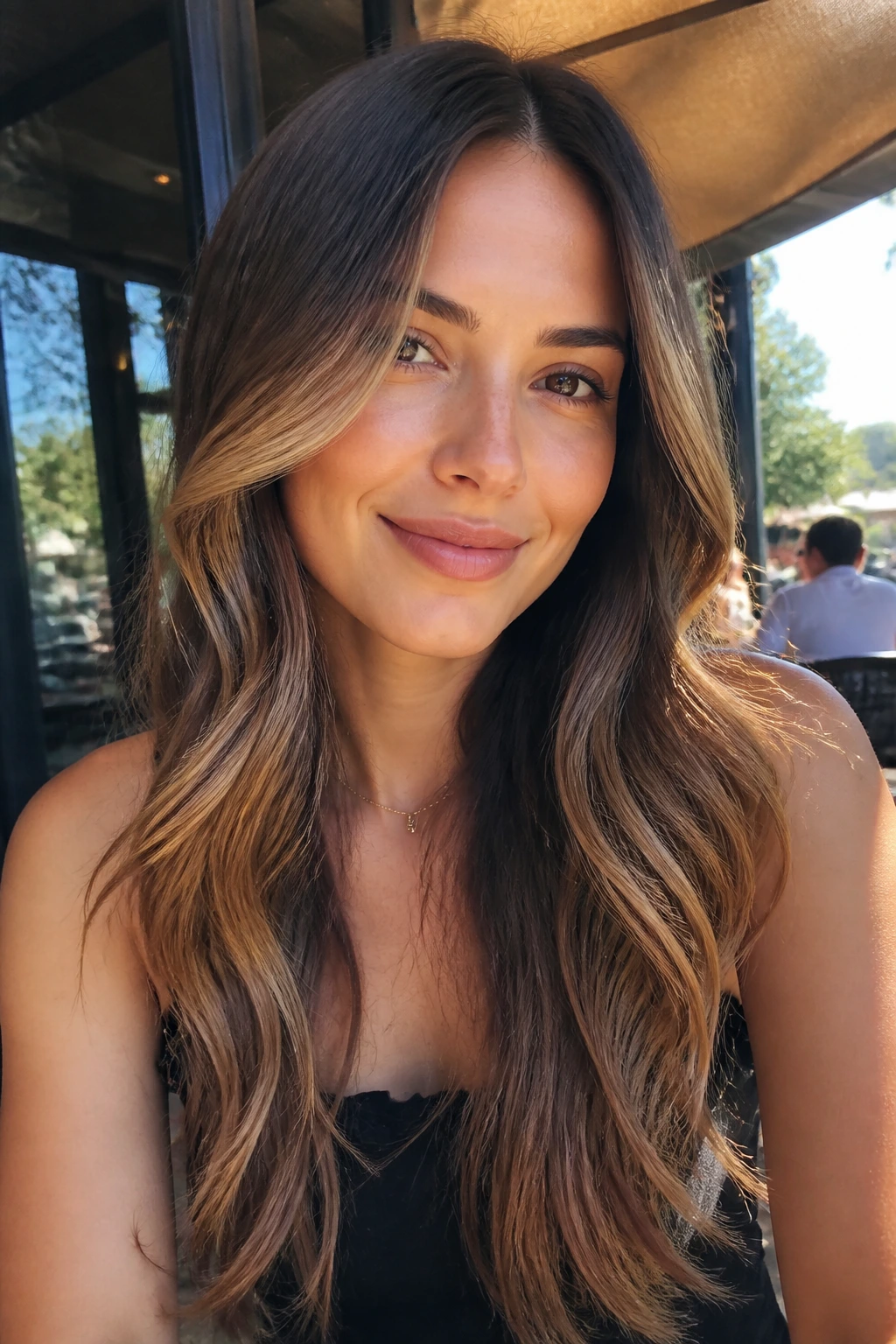 Portrait of a woman with caramel money pieces and long brown waves