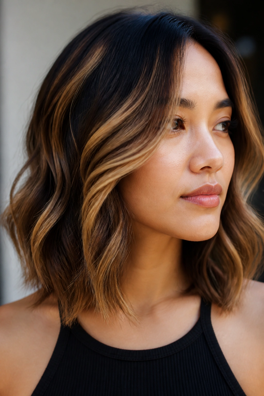 Wavy lob with chunky caramel ribbons highlighted along the waves.
