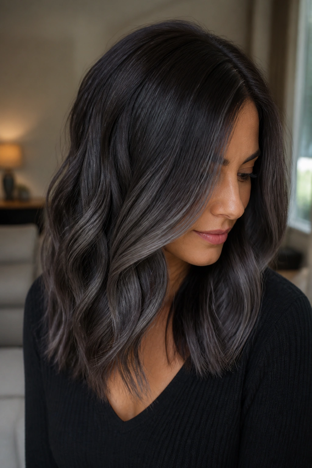 Close-up of espresso-brown hair with smoky charcoal balayage on a real woman