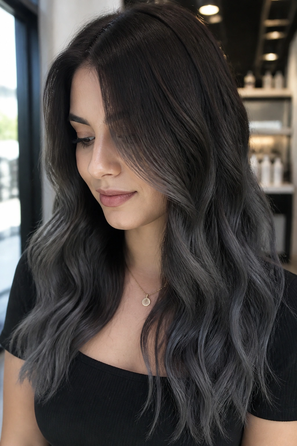 Close-up portrait of a woman with charcoal ombré on long brunette hair